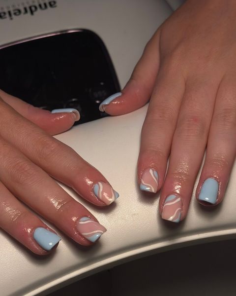 Baby blue gel nails with white and nude swirl line art